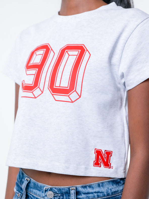 University of Nebraska - The Tip Off Graphic Baby Tee - Ash Grey